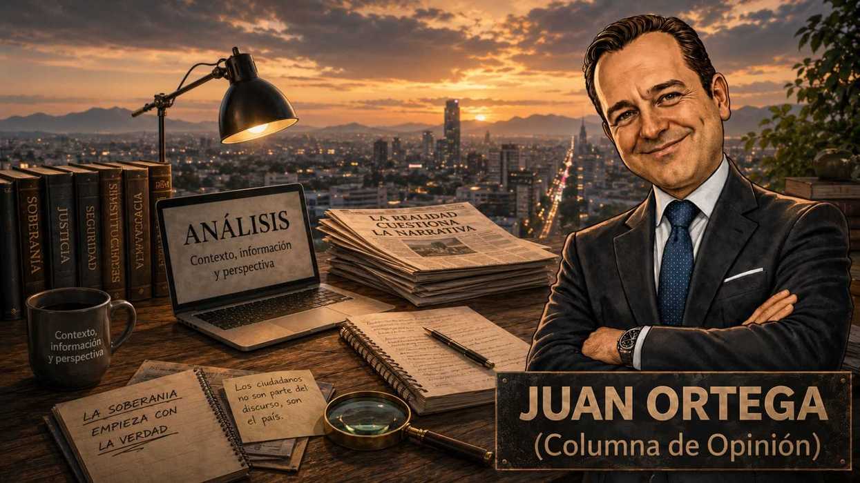 A man in a suit with crossed arms in front of a cityscape at sunset, surrounded by books.