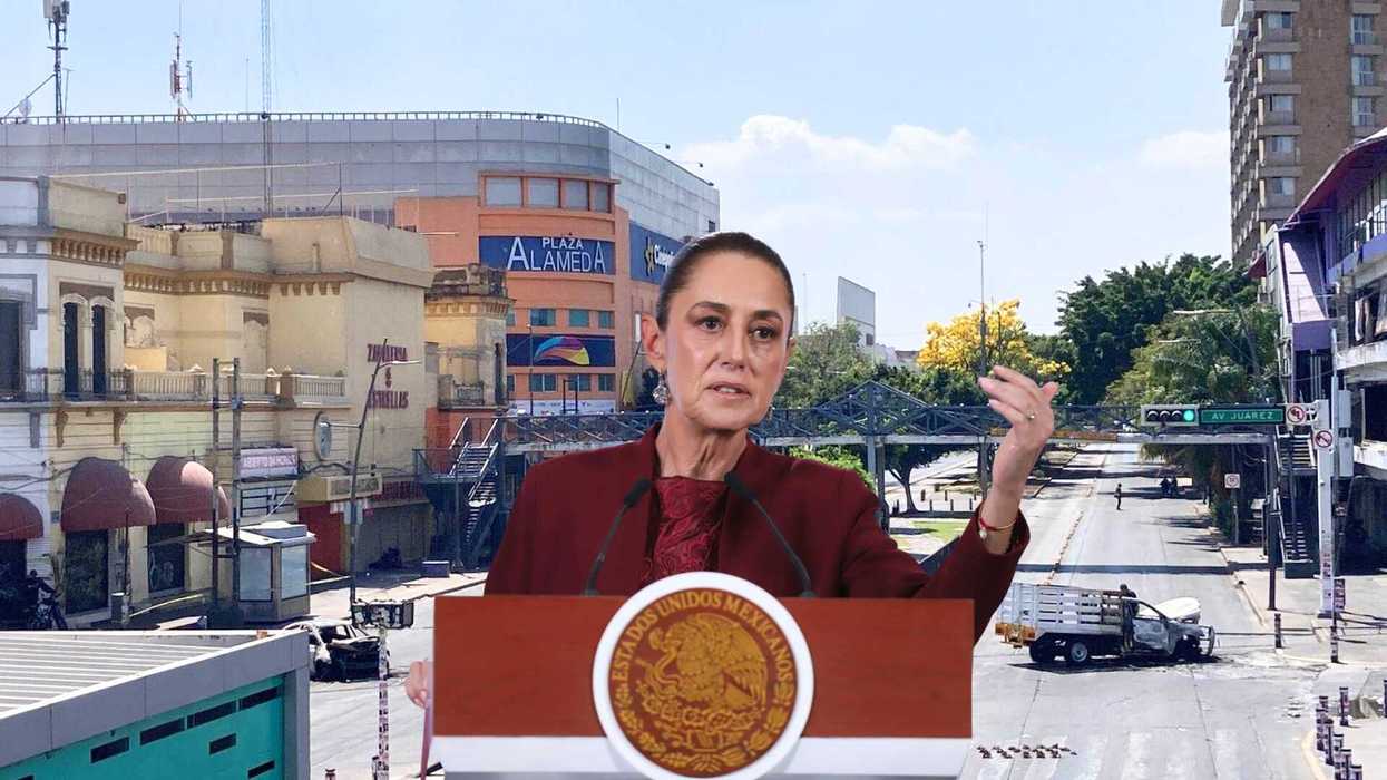 A woman speaks at a podium in front of an urban street scene and the Plaza Alameda.