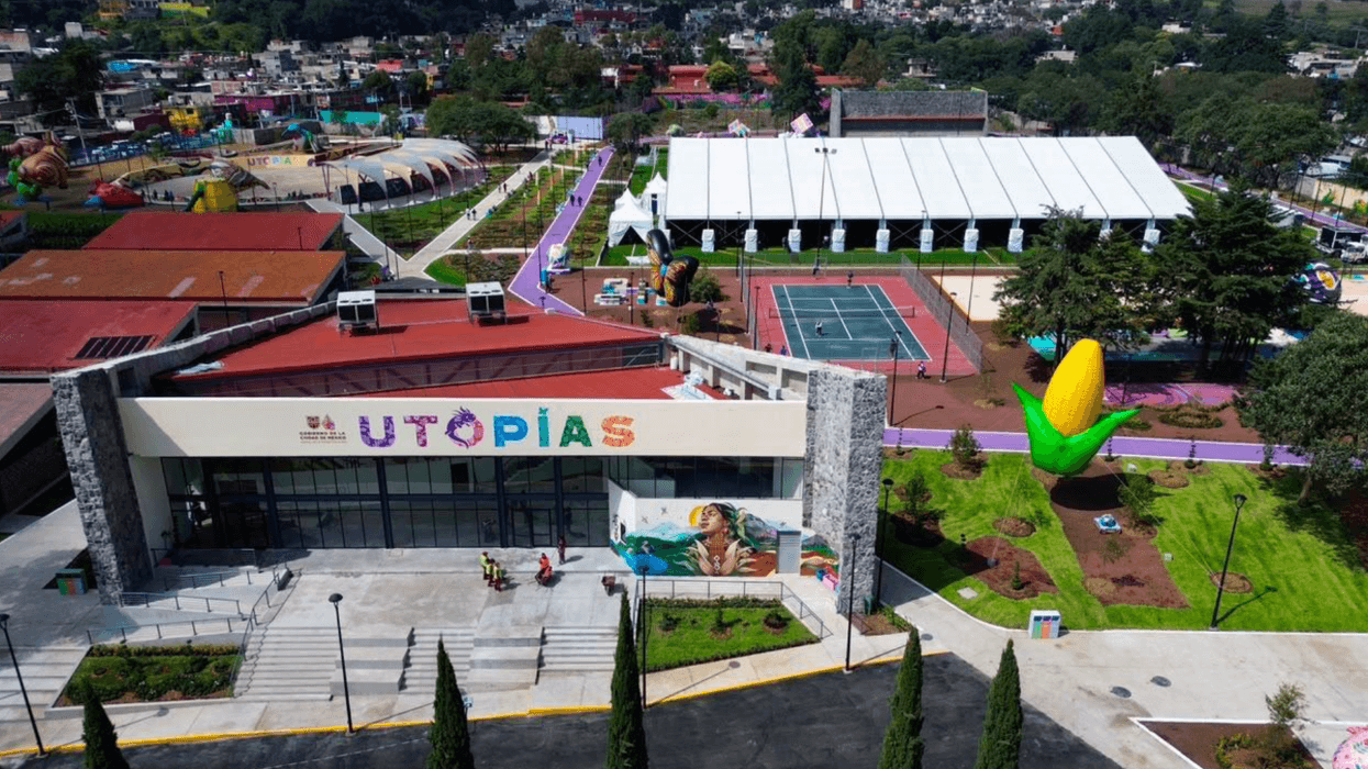 Aerial view of a colorful utopias park with a corn sculpture and a sports area.