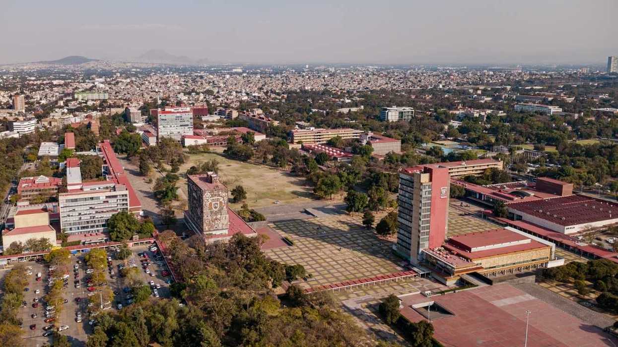 Aerial view of a large university campus with numerous buildings and greenery.