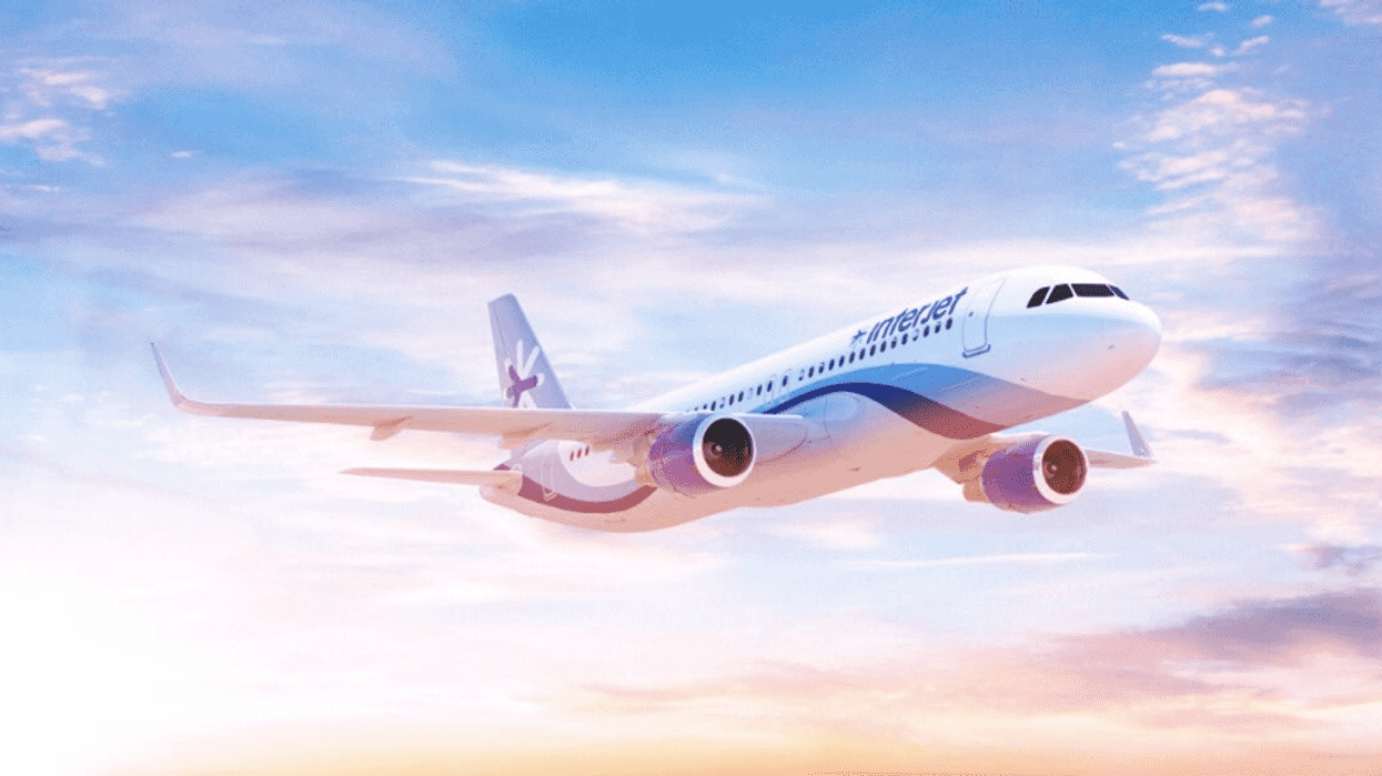 Airplane flying against a colorful sunset sky.
