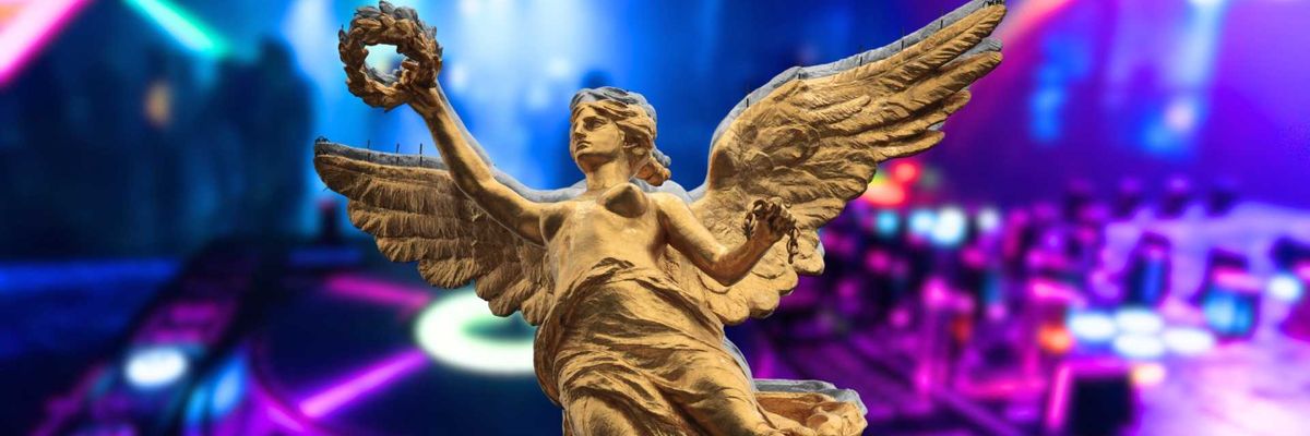 Angel statue with wings in a colorful nightclub setting.