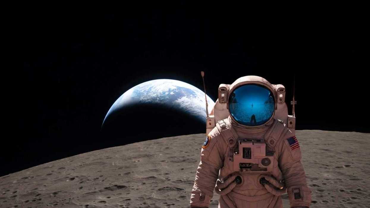 Astronaut on the Moon with Earth visible in the background.