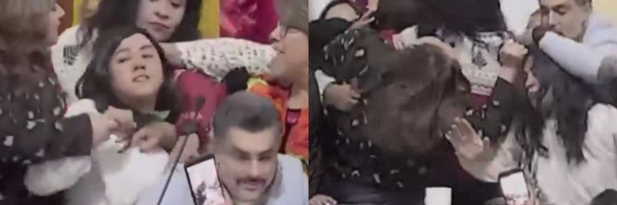 Chaotic brawl among people in a crowded room, with onlookers capturing the scene.