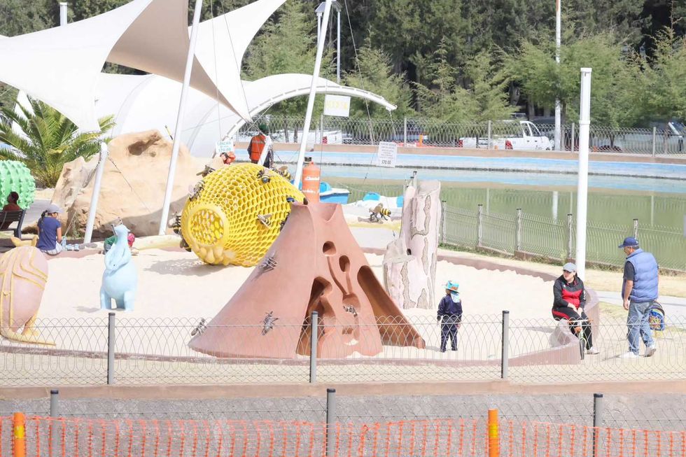 Children's playground with colorful sculptures and sand pit.