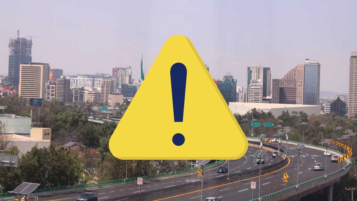 City skyline with a highway and a large yellow warning sign overlay.