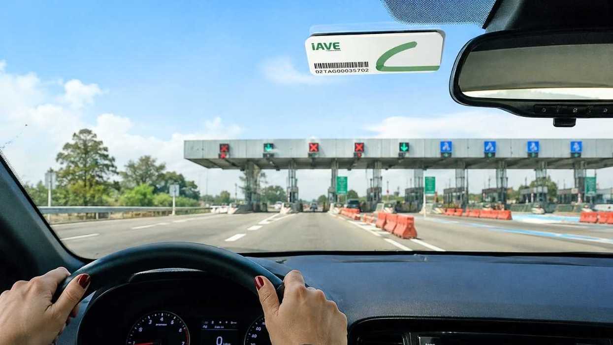 Driving towards a toll booth with open and closed lanes.