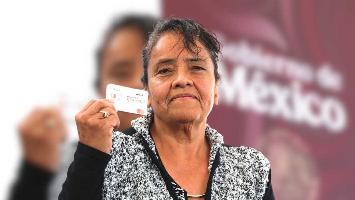 Elderly woman holding a Banco del Bienestar card with a serious expression.