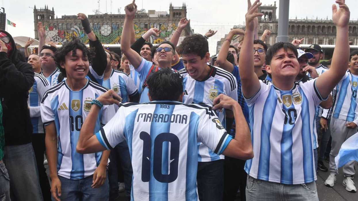 Fans celebrating in Argentina jerseys, one showing "Maradona 10" on the back.