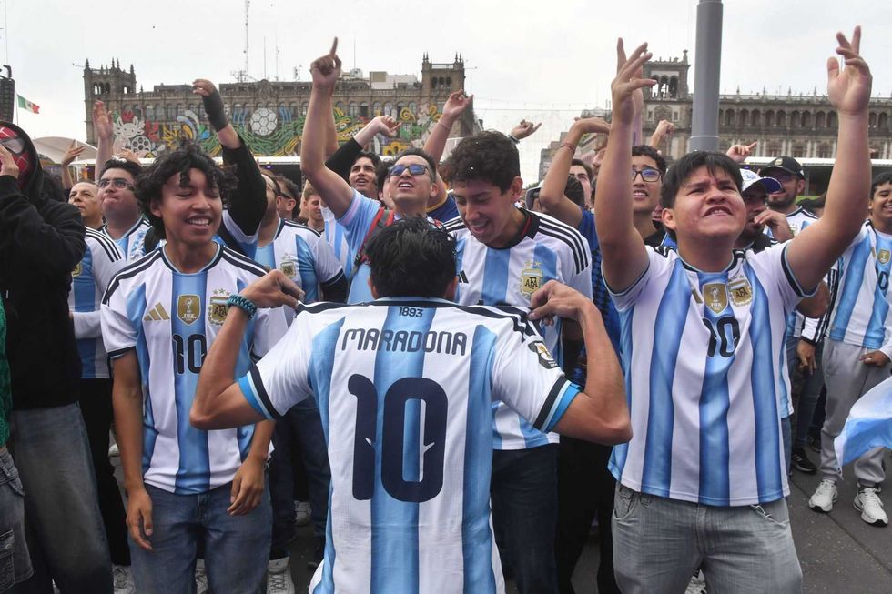 Fans celebrating in Argentina jerseys, one showing "Maradona 10" on the back.