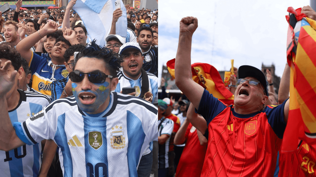 Fans in Argentine and Spanish jerseys cheer passionately with flags and face paint.