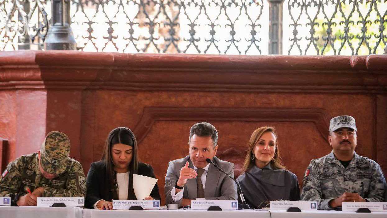 Five people seated at a table during a formal event.