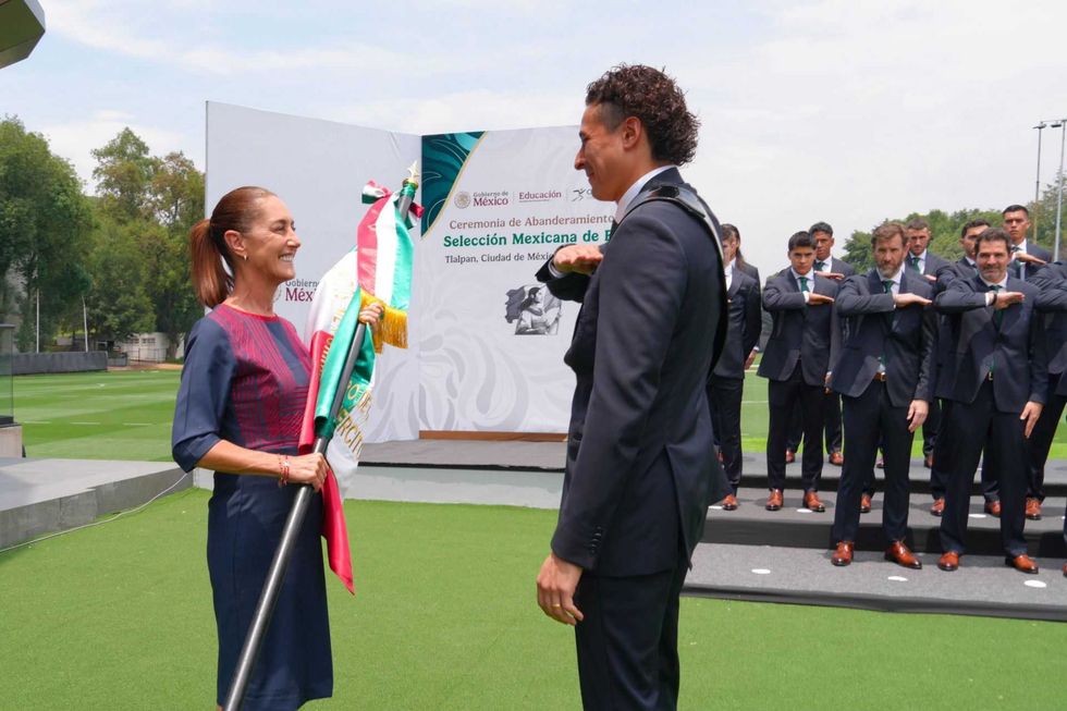 Football team flag ceremony with officials on a field.