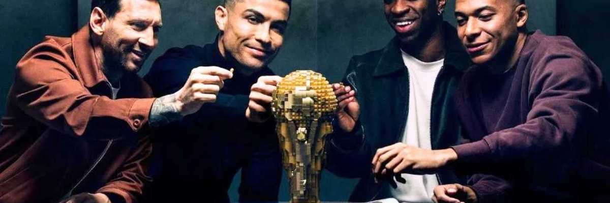 Four men assembling a golden trophy on a table, smiling and interacting.