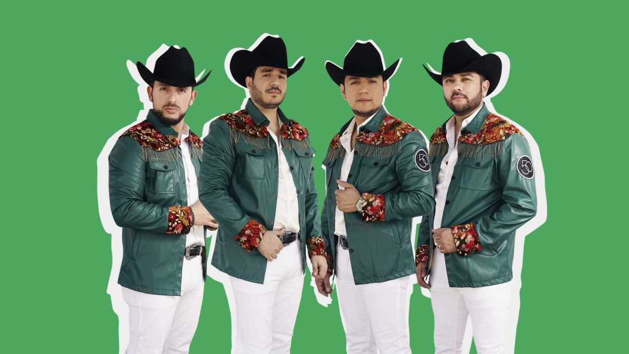Four men in matching outfits and cowboy hats stand against a green background.