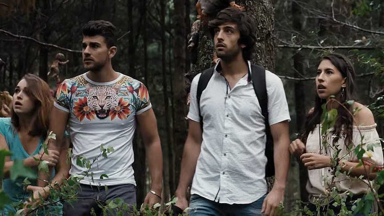Four people look worried in a dense forest setting.