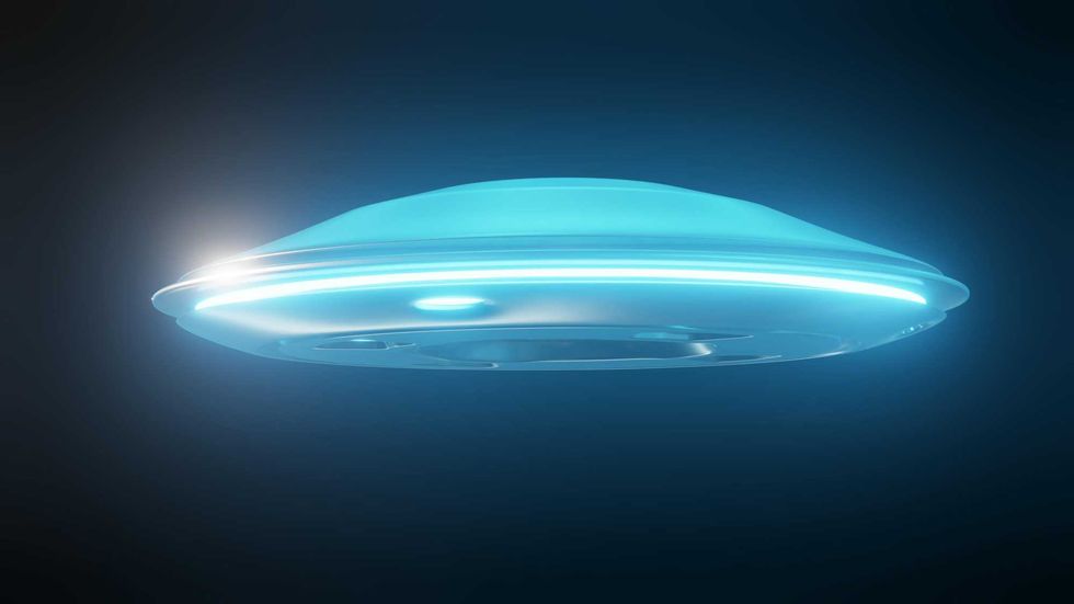 Glowing blue UFO against a dark background.