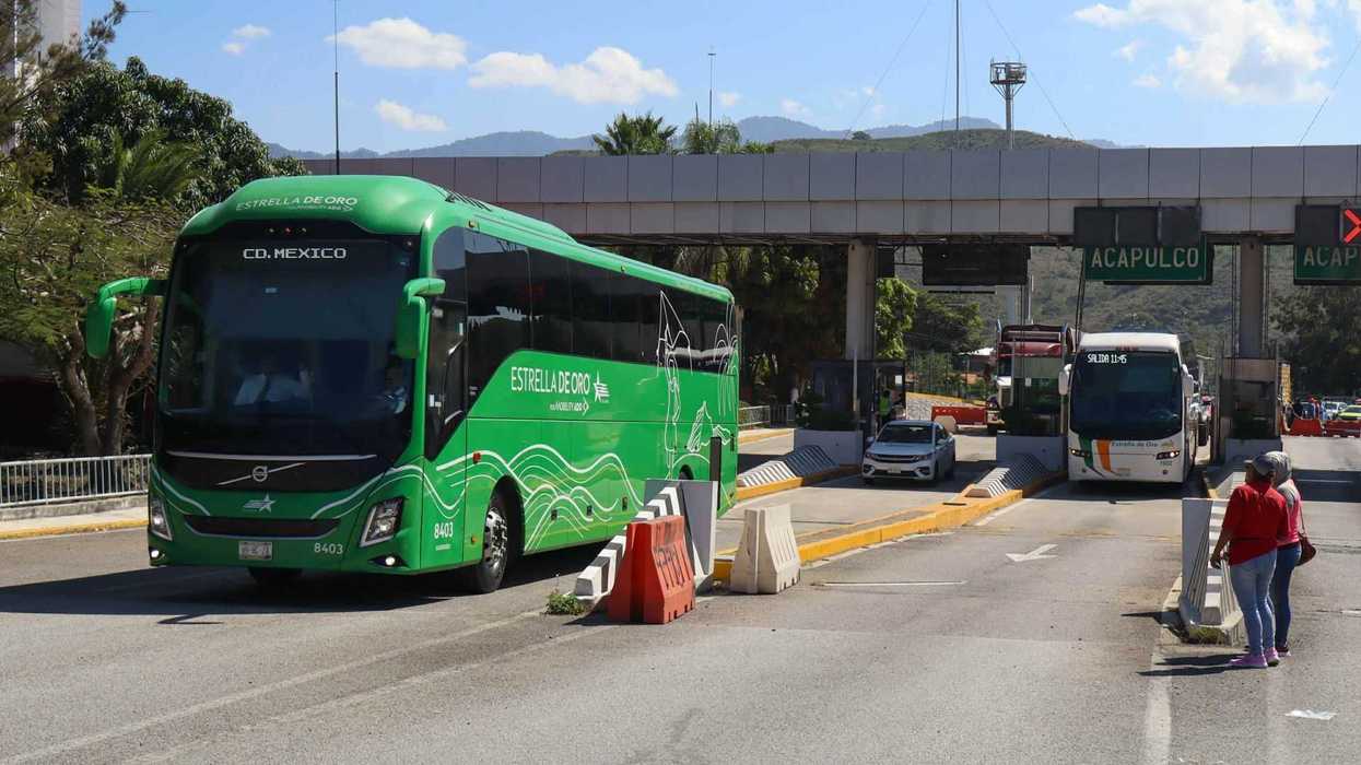 Green bus and toll booth on the road to Acapulco.