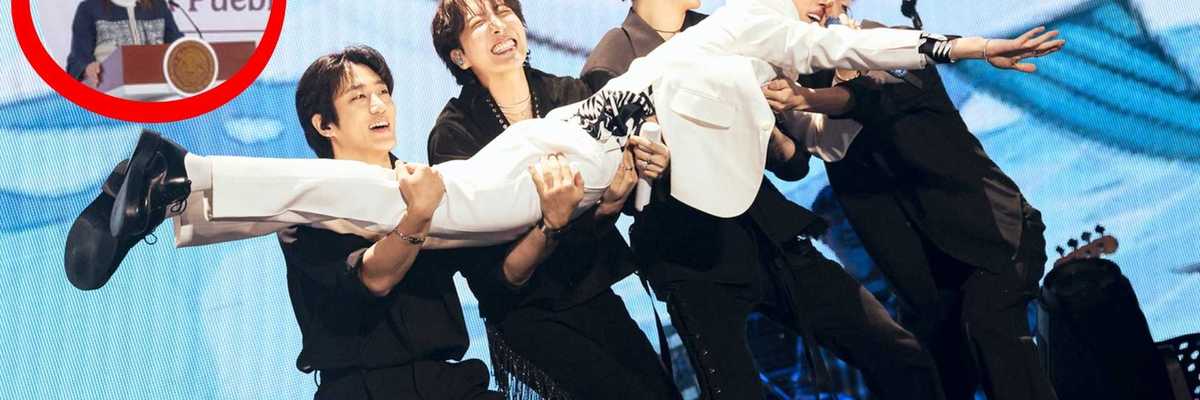 Group of five performers in black suits lifting a member in white on stage; inset of speaker.