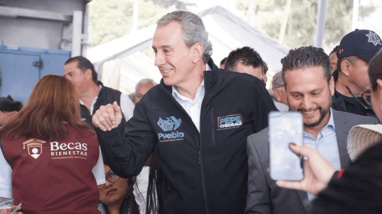 Group of people smiling and interacting at an outdoor event.