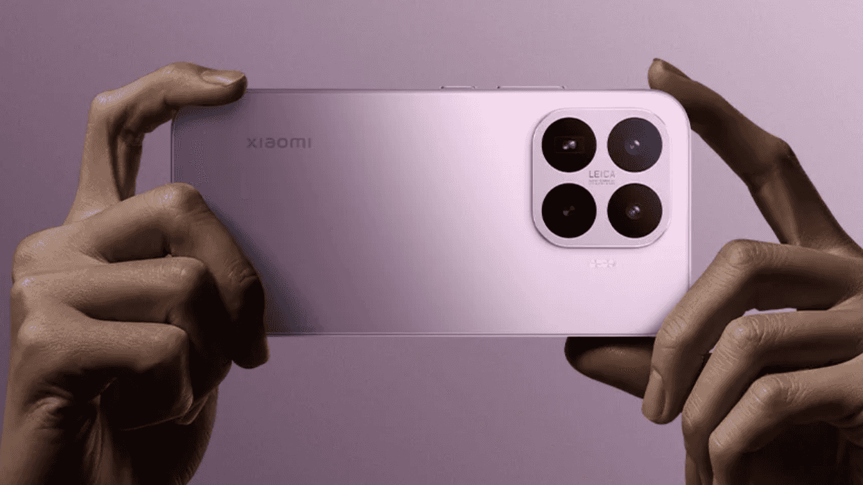 Hands holding a smartphone with a pink case and triple camera setup on a purple background.