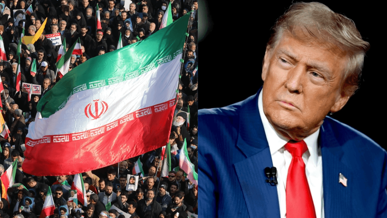 Iranian flag waving in a crowd next to a person in a suit.