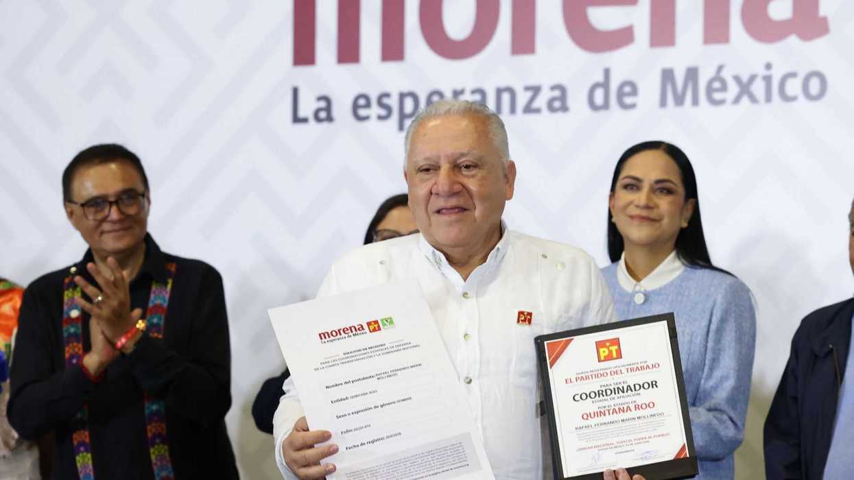 Man holding documents, smiling, with
