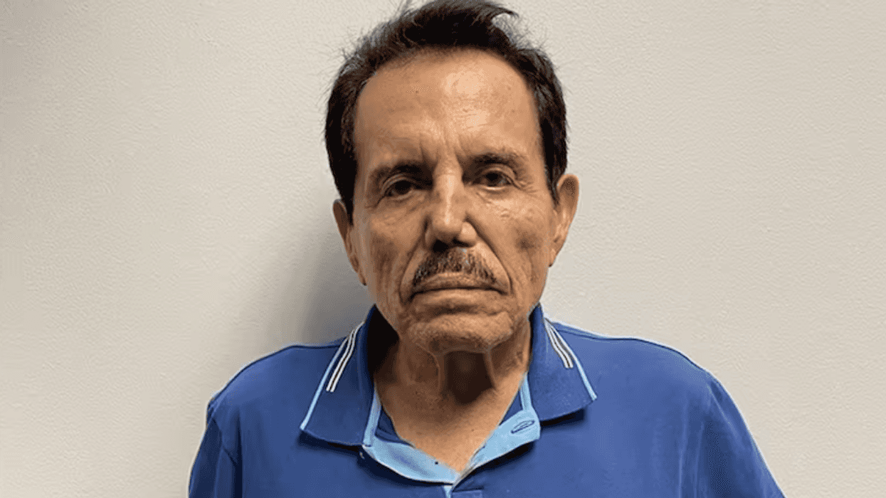 Man in a blue polo shirt against a plain white background.