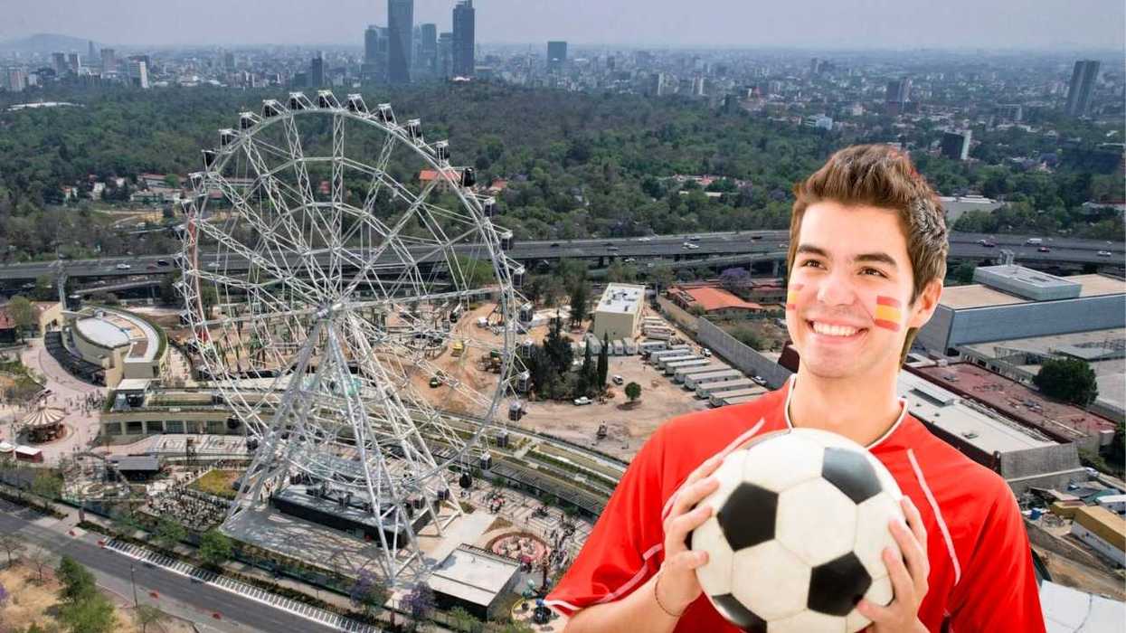 Man with a soccer ball by a Ferris wheel in a cityscape background.