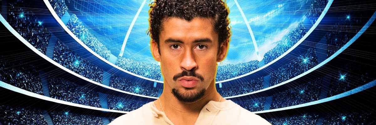 Man with curly hair in a futuristic stadium with blue lights.