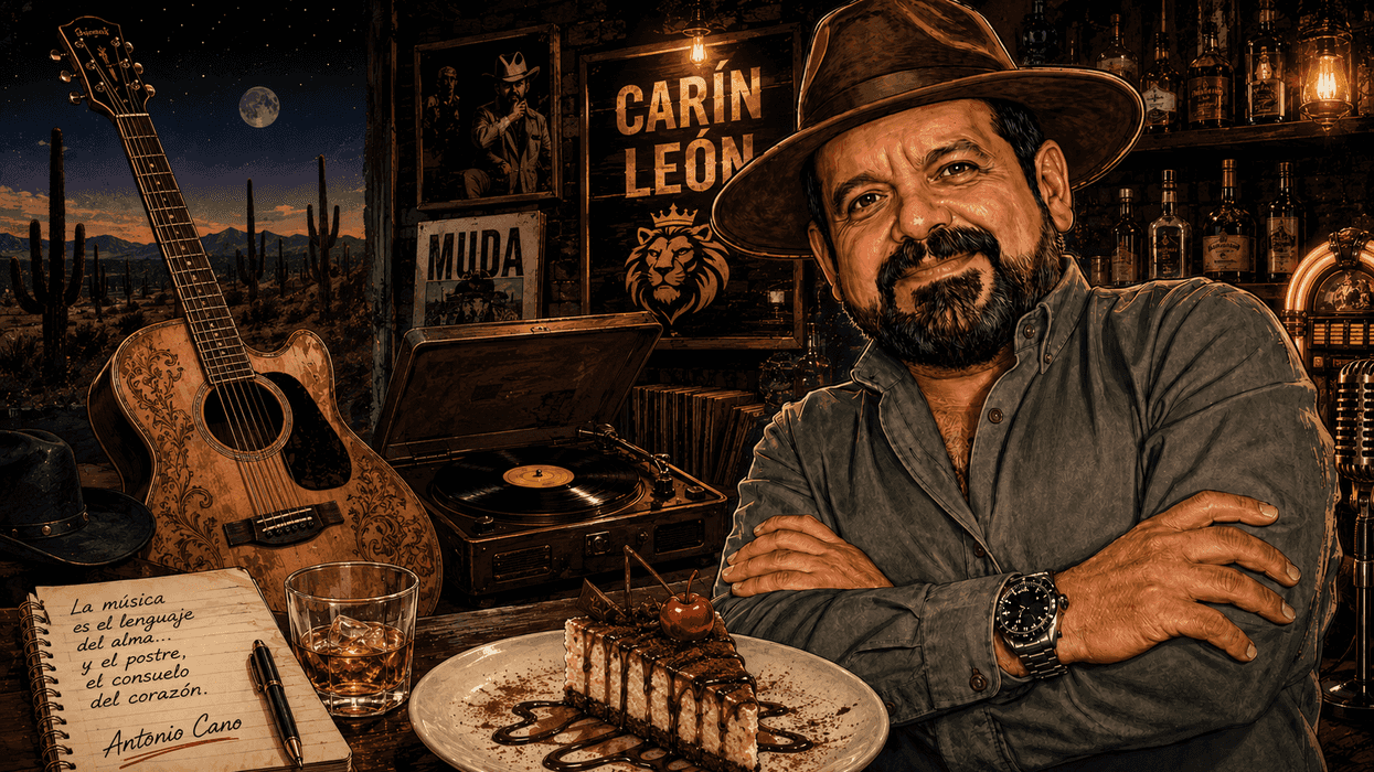 Man with hat in rustic bar, guitar, cake, and vintage record player in background.