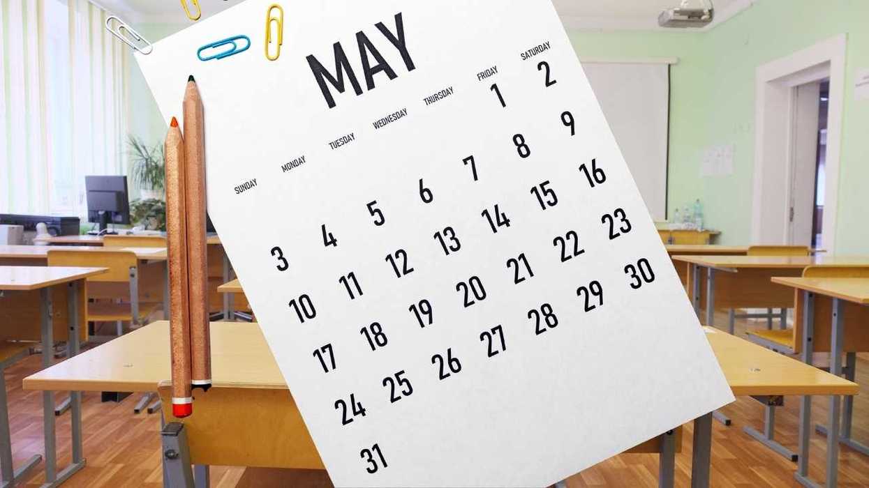 May calendar with pencils and paperclips in an empty classroom.