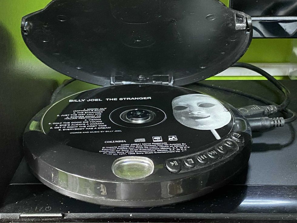 Open CD player with Billy Joel's "The Stranger" disc inside.
