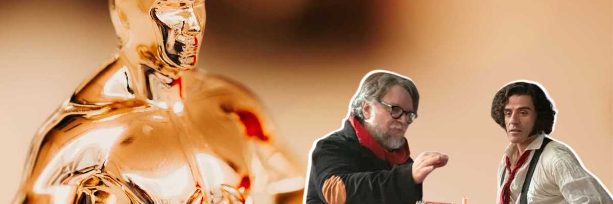 Oscar statue beside two men working on a model with a blurred background.