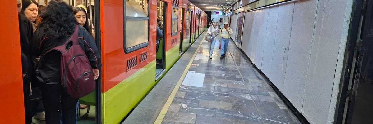 People boarding a subway train at a station platform with tiled flooring and overhead lights.