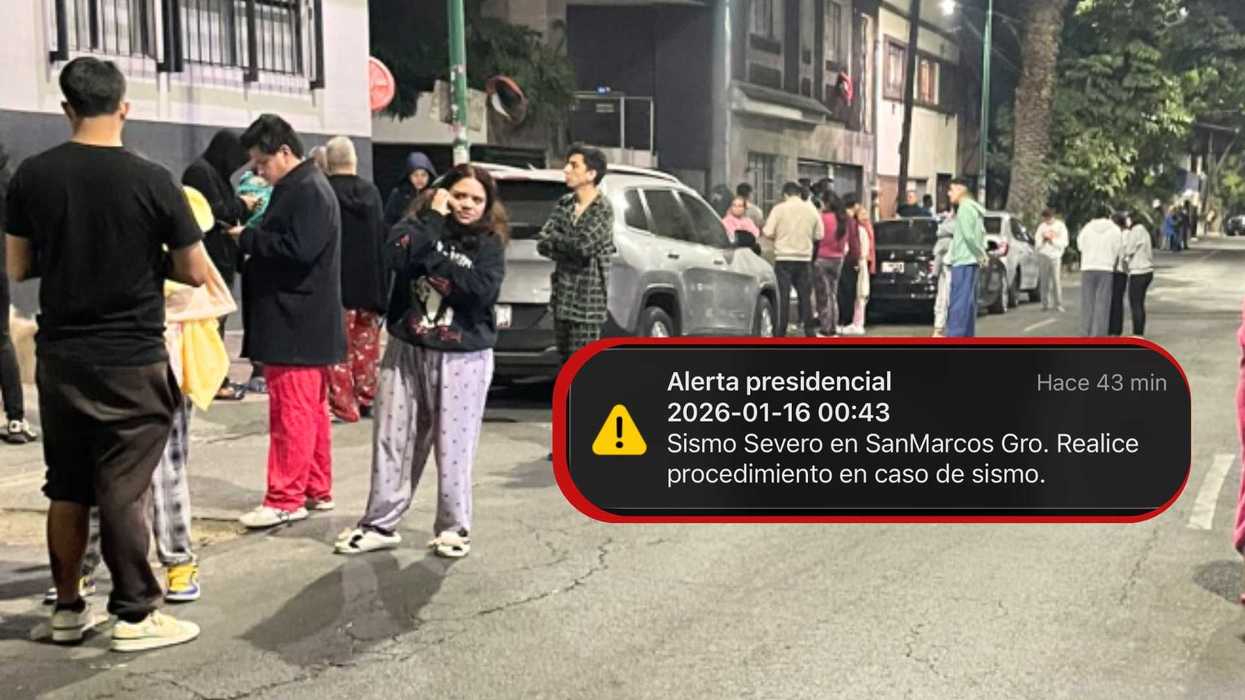 People in pajamas gather outside after earthquake alert in San Marcos at night.