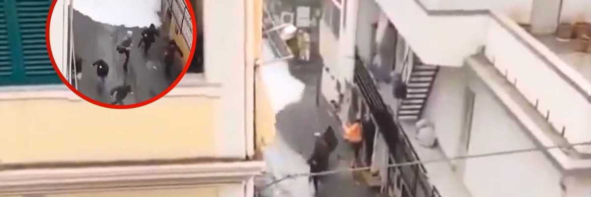 People running from a sudden foam flood in a narrow alleyway.