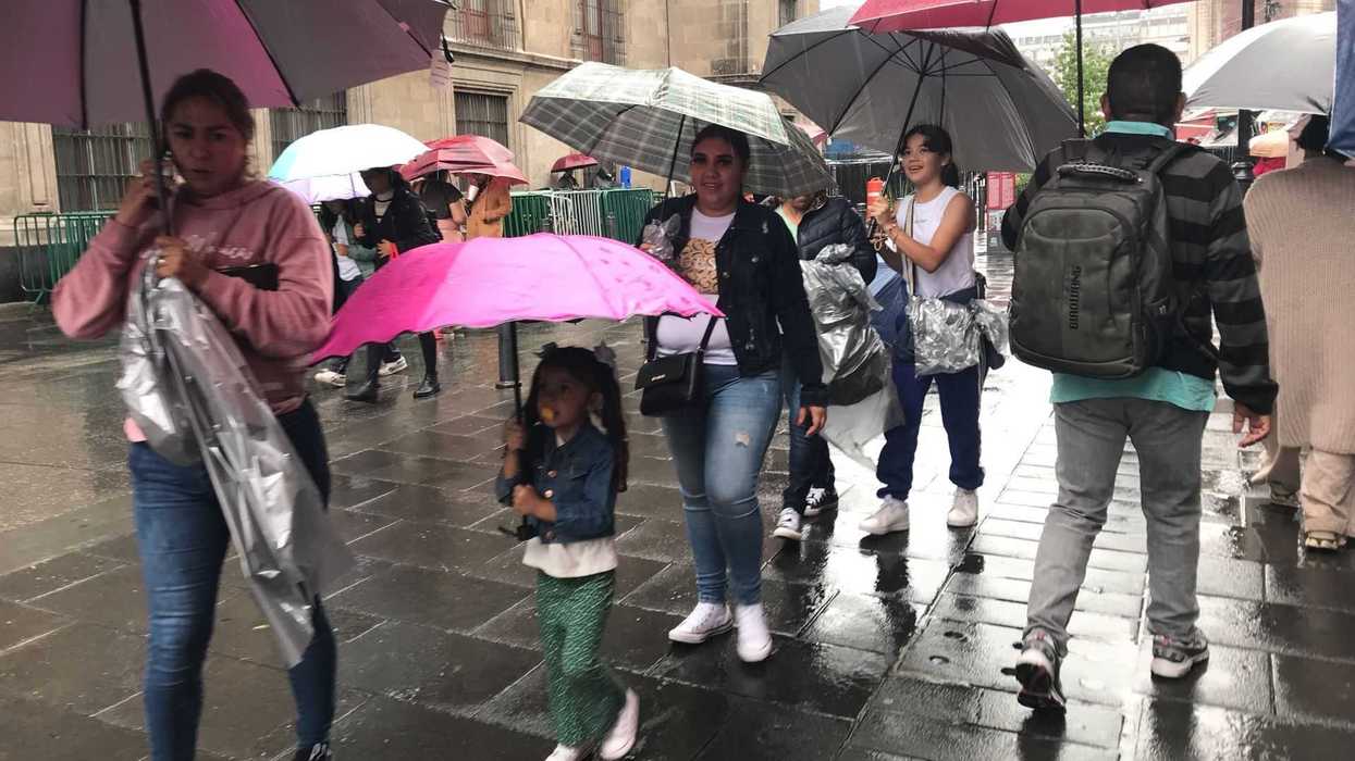 People walking with umbrellas on a rainy street.