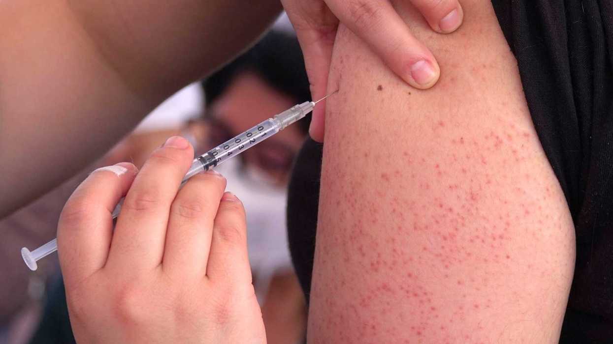 Person receiving an injection in the upper arm.