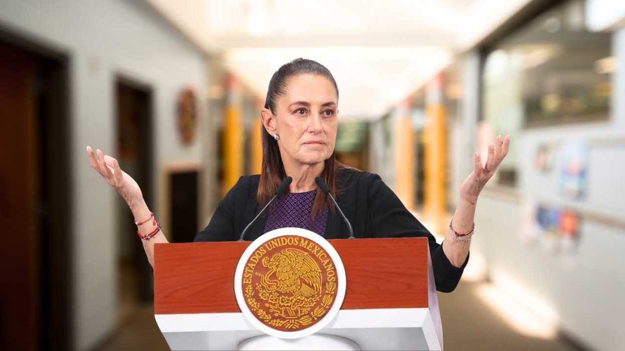 Person shrugging at a podium with Mexican seal in a hallway.