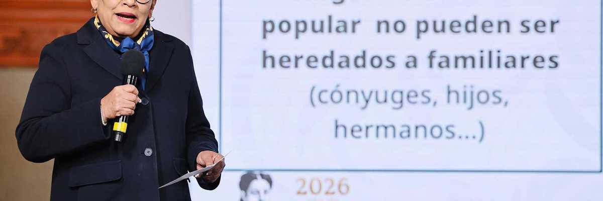 Person speaking near a screen displaying a message about political positions and family inheritance.