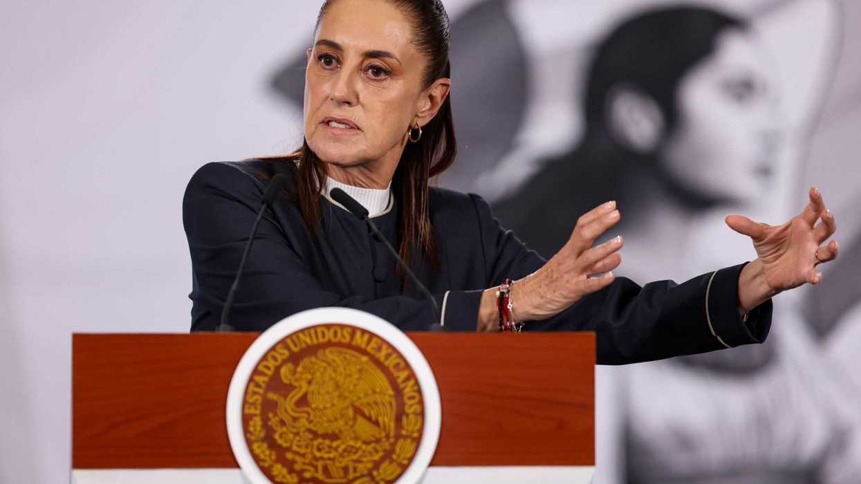 Person speaking passionately at a podium with the Mexican seal.