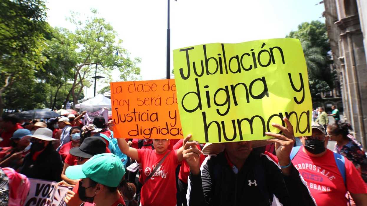 Protesters hold signs demanding justice and dignified retirement in a sunny outdoor march.