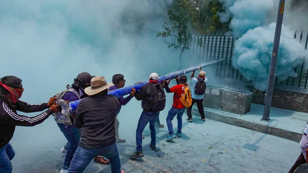 Protesters use a homemade launcher to create smoke during a demonstration.