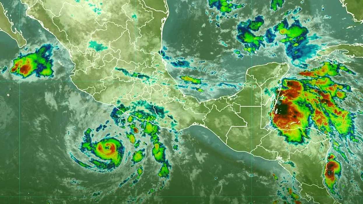 Satellite view of a swirling cyclone off Mexico with colorful cloud formations.