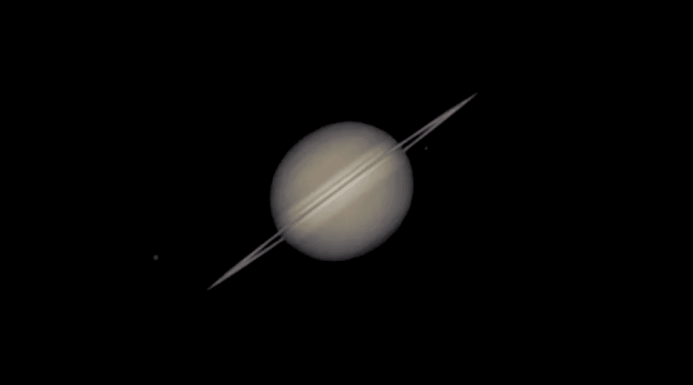 Saturn with its prominent rings, viewed in space against a dark background.