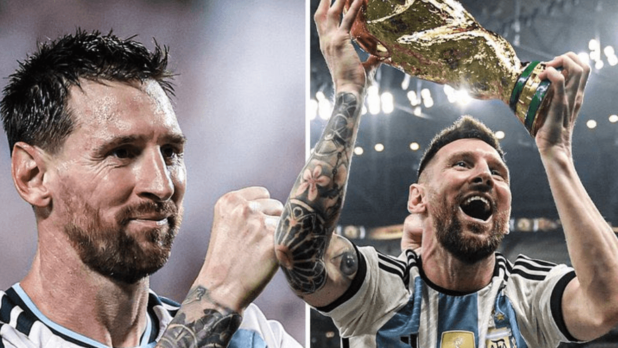 Soccer player celebrating and lifting a trophy in Argentina jersey.