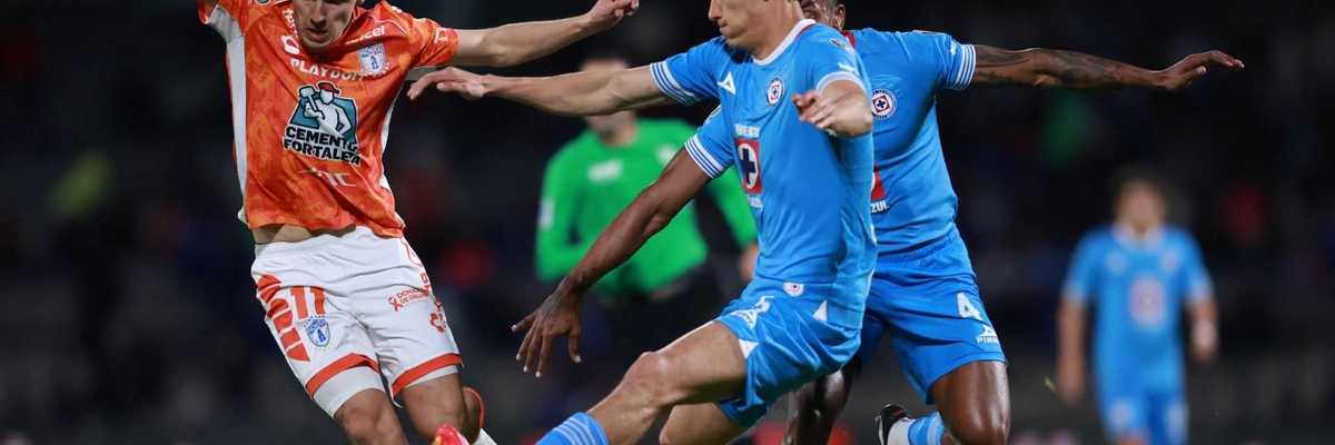 Soccer players from rival teams vie for ball possession on the field.