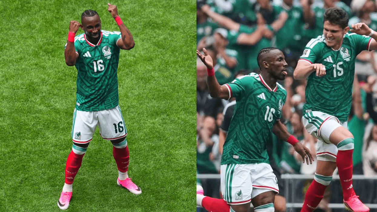 Soccer players in green jerseys celebrating on the field.