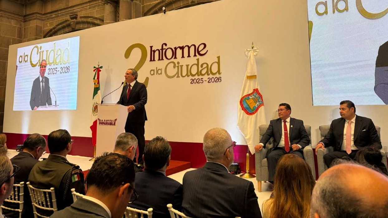 Speaker at podium during a city report presentation event with attendees seated.